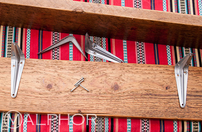 Fixing the brackets onto the shelf