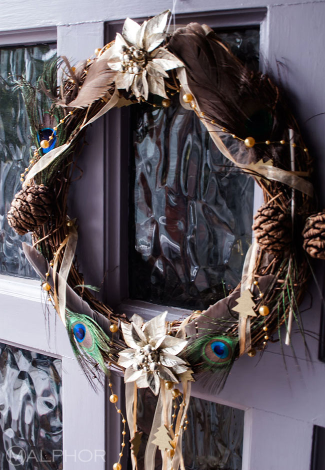 Peacock feathers Christmas wreath on purple door